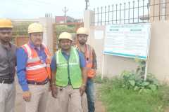 four-man-standing-in-safety-vest-and-hard-hat.jpg